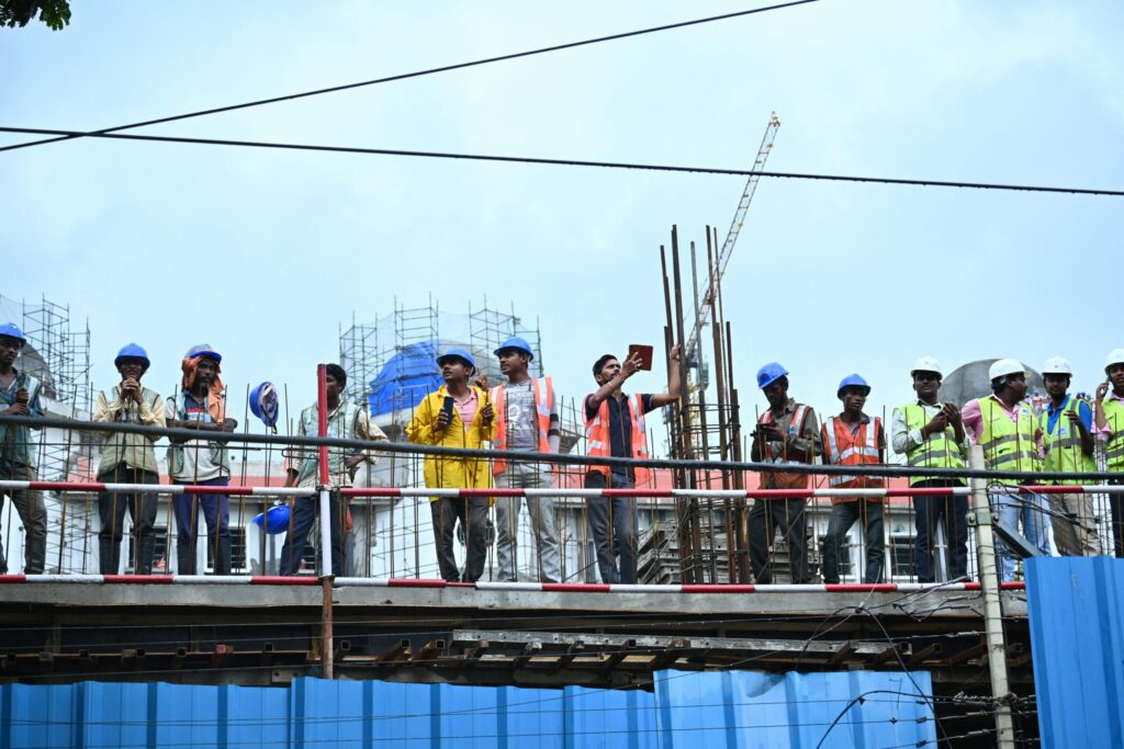 a construction crew lined up on scaffolding